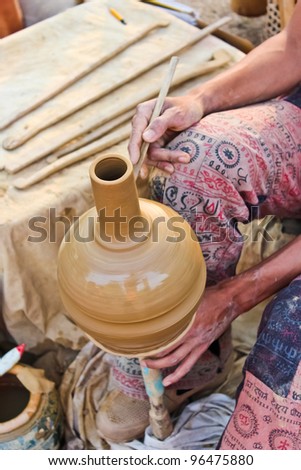 Close-up of potter turning a pot on a potter s wheel