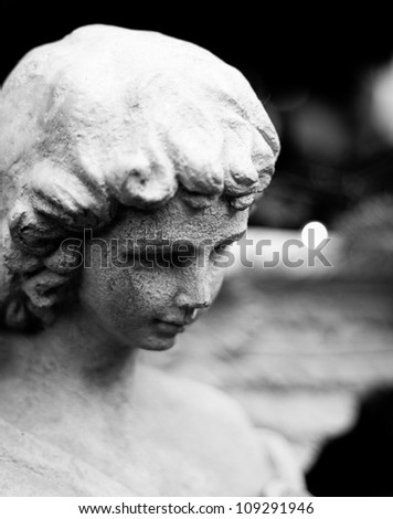 Black and white picture of an angel statue  in a reflective mode.