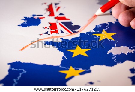 Hand drawing a red line between the UK and the rest of the European Union. Concept of Brexit. The UK is thus on course to leave the EU on 29 March 2019