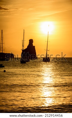 Quiet scene: Sailboats in a harbor at sunset. Mediterranean sea of Ibiza island