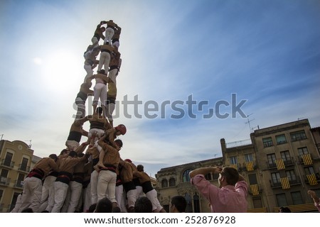 REUS, SPAIN - OCTOBER 25, 2014: Castells Performance, a castell is a human tower built traditionally in festivals within Catalonia. This is alsoon the UNESCO Intangible Cultural Heritage of Humanity