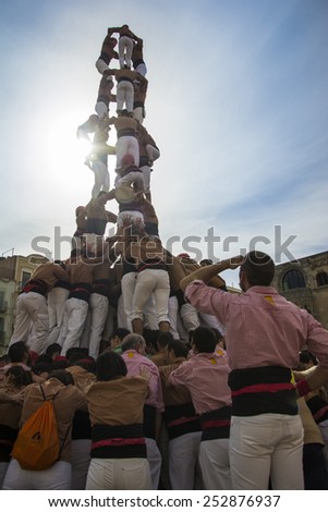 REUS, SPAIN - OCTOBER 25, 2014: Castells Performance, a castell is a human tower built traditionally in festivals within Catalonia. This is alsoon the UNESCO Intangible Cultural Heritage of Humanity
