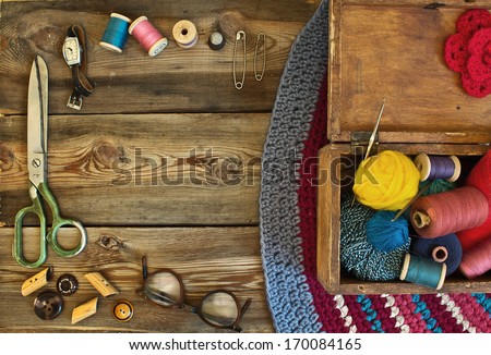 Sewing Accessories: Scissors, Thimble, Thread, Sunglasses, Watches, Jewelry Box On A Wooden Table