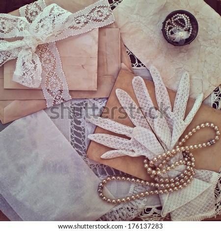 Vintage women's jewelry and gloves. Bundle of old letters with lace ribbon