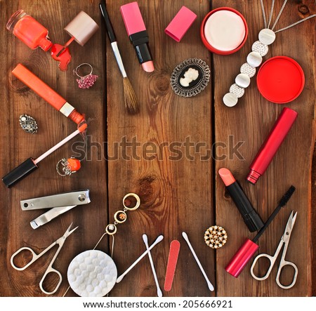 Set of cosmetics and women\'s jewelry on wooden background