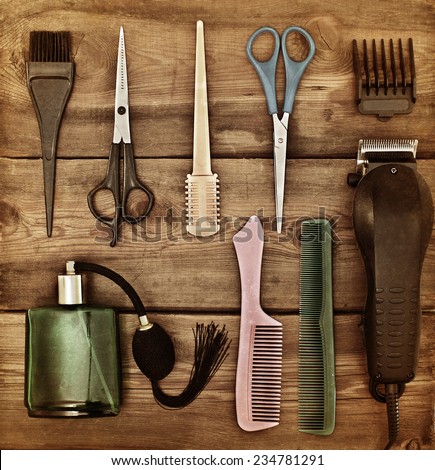 Hairdressing accessories. Retro concept. Scissors and combs on a wooden table. Toning