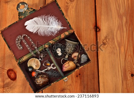Vintage box with trinkets and women\'s jewelry on wooden background