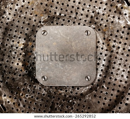 Grungy metal background. Frame with bolted to a perforated metal panel