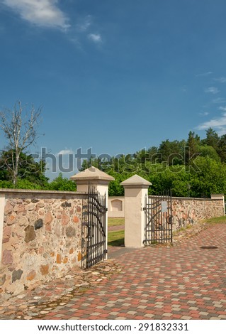 Stone fence with gate. Courtyard
