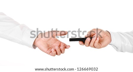 Male hand holding a mobile phone and handing it over to another person isolated