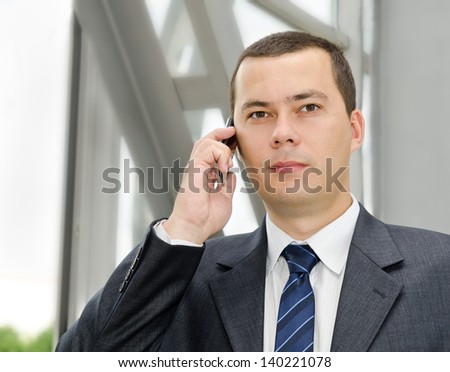 Portrait of young  businessman calling by mobile telephone
