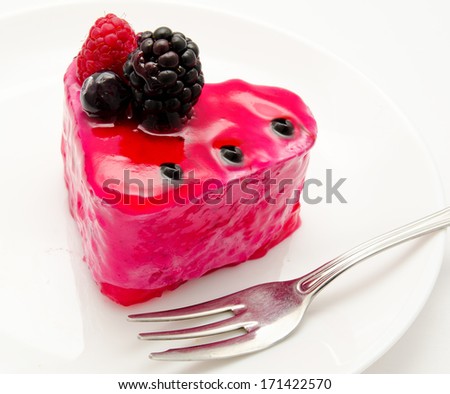 Fruit jelly cake and fork on the plate isolated on a white background
