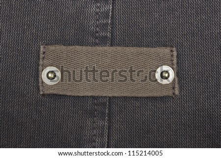 Blank jeans label. Fragment of jeans with pure label for your text.