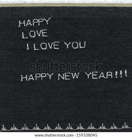Background denim texture with words happy, love, I love you, happy new year sewed on it
