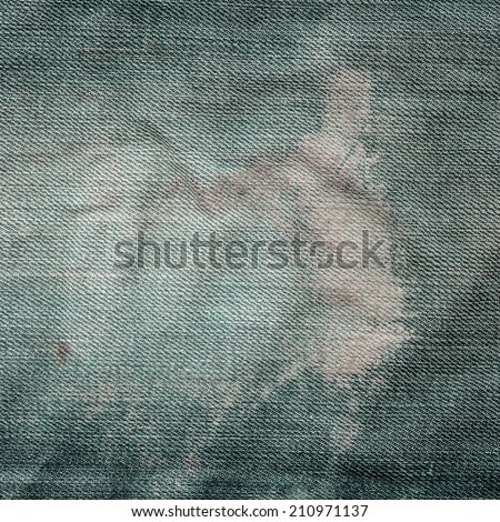 worn old green jeans texture closeup