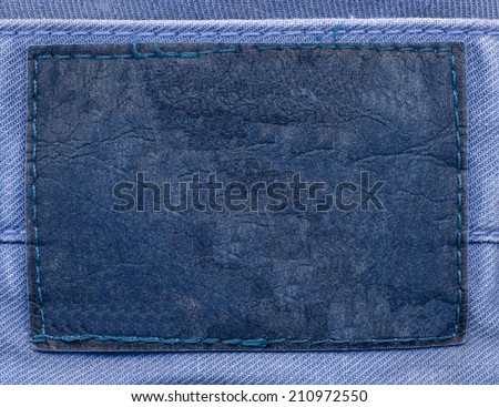 blank old  blue  leather label on fabric background