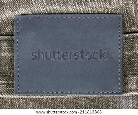 blank blue leather label on  brown jeans background
