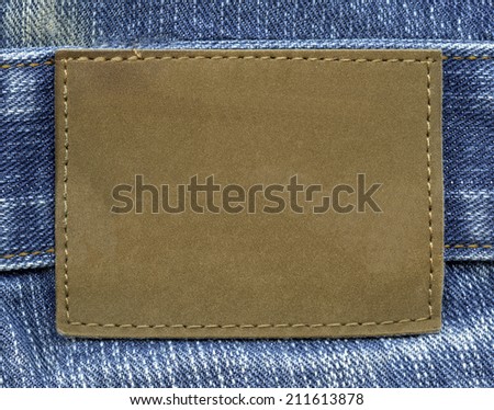 blank  leather label on  blue jeans background