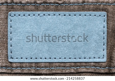 blue blank  label on brown jeans background