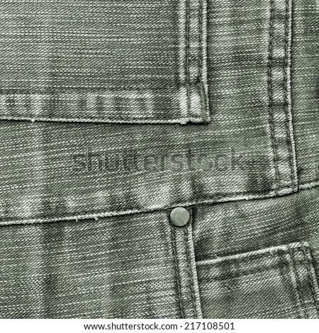 fragment of gray-green jeans as background