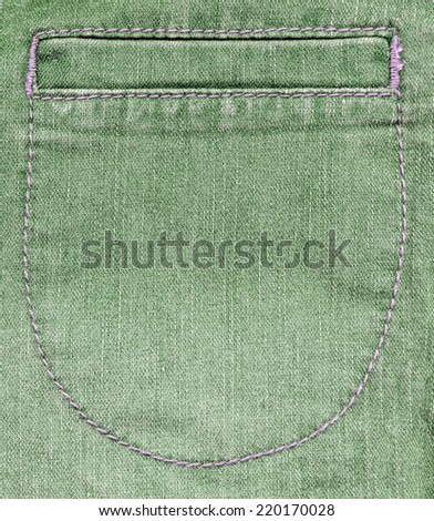 fragment of female green denim trousers  with a false pocket