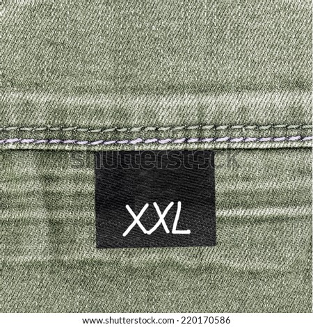 gray-green jeans texture, seam, tag, size