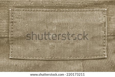 blank brown fabric label on   textile background