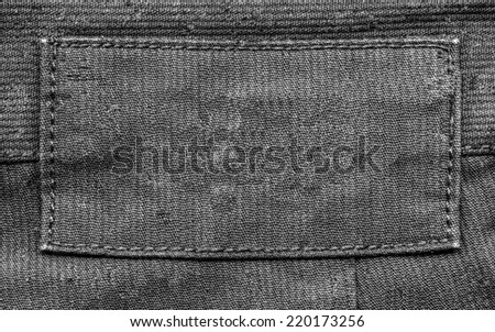 blank black fabric label on black  textile background