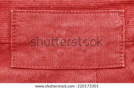 blank red fabric label on  red textile background