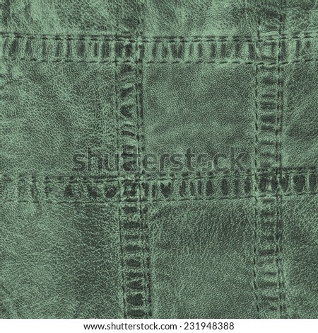 green leather background..Fragment of leather clothing accessories