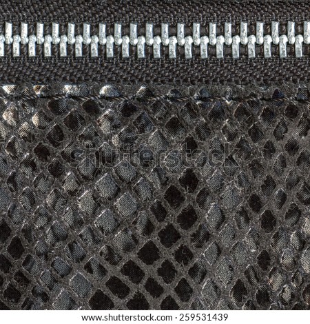 fragment of  ladies handbag imitation snakeskin closeup, zipper