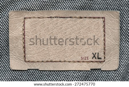 pale brown  leather label on denim background, size