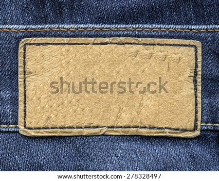 beige leather label on jeans background