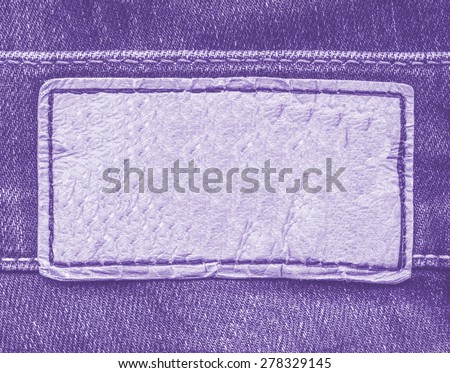 violet leather label on violet jeans background