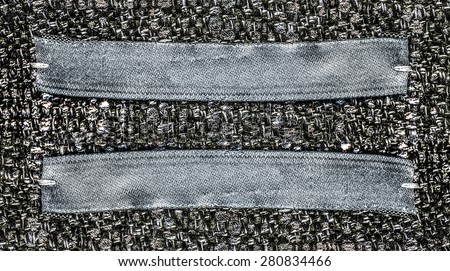 gray-blue textile labels on gray textile background, blank labels for your text