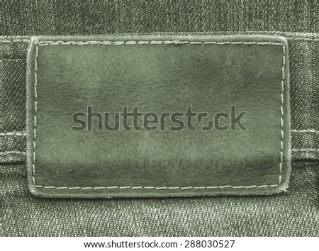 green  leather label on  jeans background