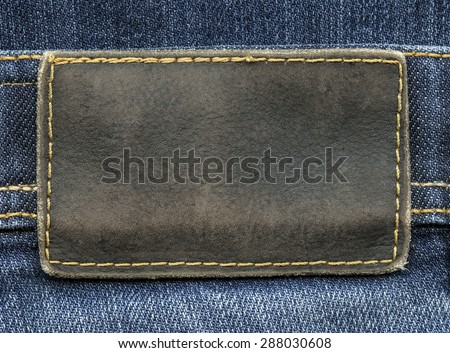 brown leather label on  jeans background