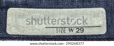 white textile tag on blue jeans background