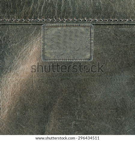 gray leather label on leather background. Textures