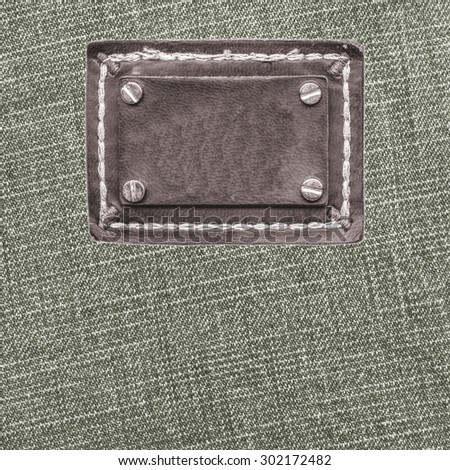 gray denim texture, blank brown leather label