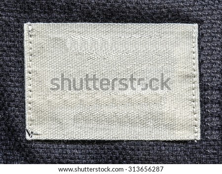 white textile tag on gray textile background