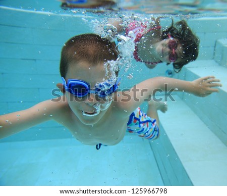 Boy and girl swimming underwater