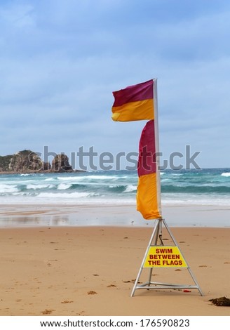 Surf life-saving flags at the beach with warning to swim between the flags