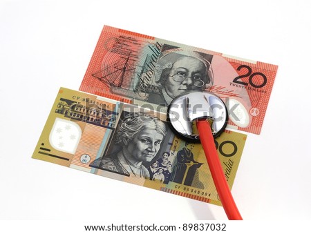 Stethoscope with Australian banknotes, isolated over white