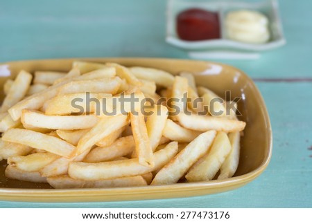 Traditional French fries with ketchup on dish