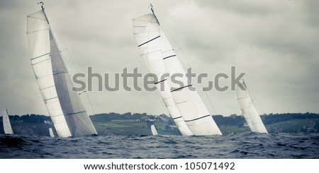 group yacht sailing  in storm with waves