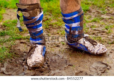 dirty shoes with mud at rugby or football sport