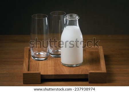 Glass bottle of ayran (turkish yogurt drink) on the wooden table