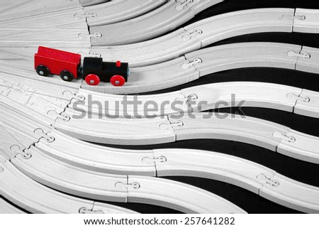 concept of decision making process - wooden toy train on the multiple rails intersect