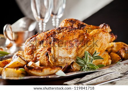 Photograph of a tasty roasted chicken served in a plate
